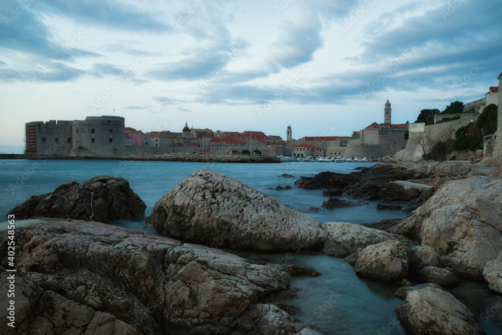 Croatia, Sunrise in Dubrovnik, a landscape overlooking the old town and large stones in the foreground