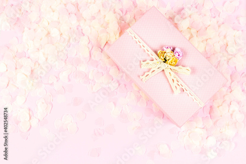 Pink gift box full of tender pink hearts of confetti on pastel background. Valentine's Day, wedding, love concept. Top view, flat lay, copy space. © Lyubov