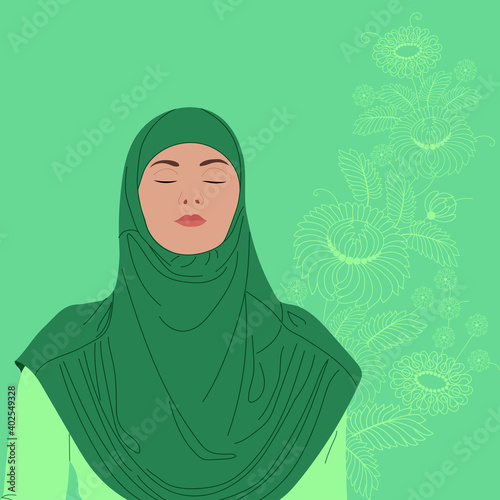 Beautiful girl in green dressing with hijab poses  smiling on on the flowers background close view