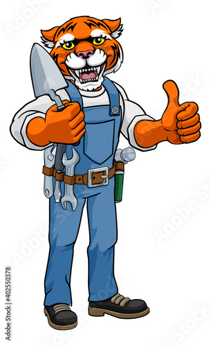 Fototapeta Naklejka Na Ścianę i Meble -  A tiger bricklayer builder construction worker mascot cartoon character holding a trowel tool and giving a thumbs up