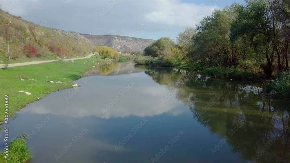 Drone flight over the river and smal moldavian village in autumn landscape. Moldova republic of. Drone flight over the river and smal moldavian village in autumn landscape. Moldova republic of.