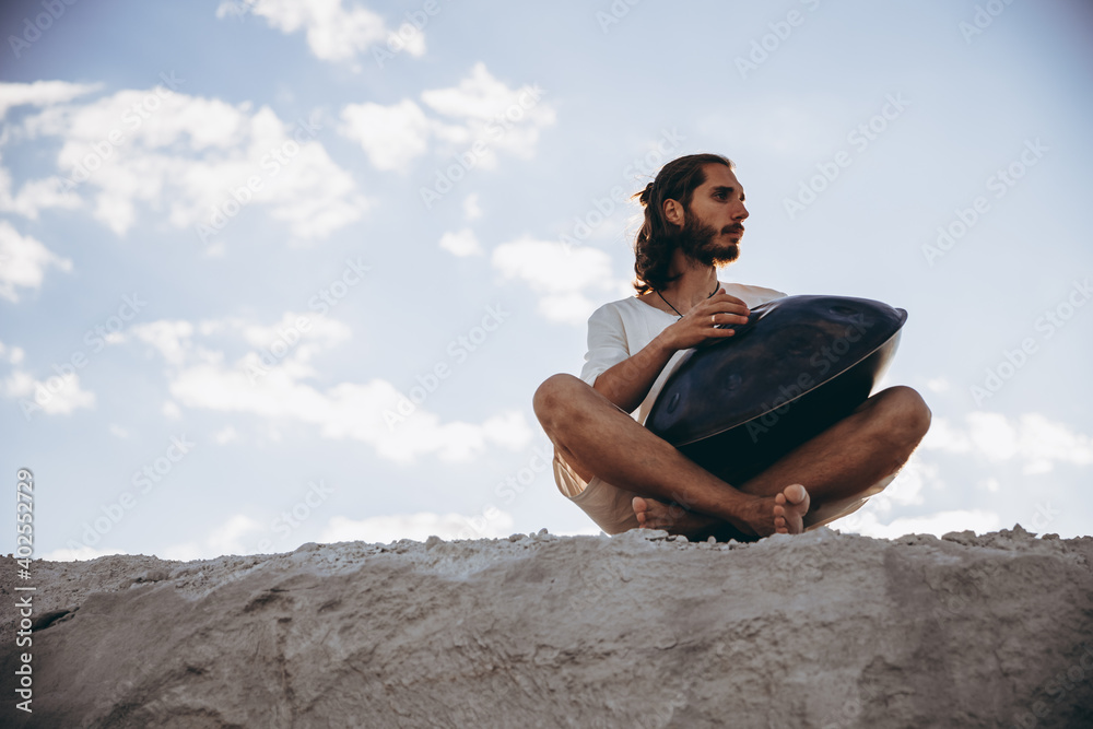 Man' s hands playing hang drum