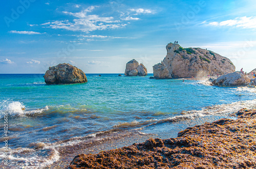 Aphrodite Beach with Stone Rocks in Aphrodite bay of Mediterranean sea water, blue sky in sunny day background, Petra tu Romiou, Cyprus photo