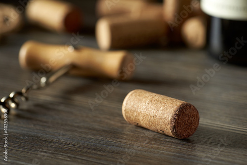 A closeup of a cork from a bottle of wine lies on a wooden table