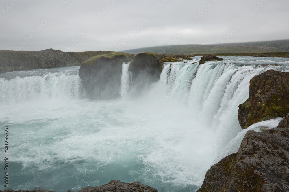The Godafoss (Icelandic: waterfall of the gods) is a famous waterfall in Iceland. The breathtaking landscape of Godafoss waterfall attracts tourist to visit the Northeastern Region of Iceland The Godafoss (Icelandic: waterfall of the gods) is a famous waterfall in Iceland. The breathtaking landscape of Godafoss waterfall attracts tourist to visit the Northeastern Region of Iceland
