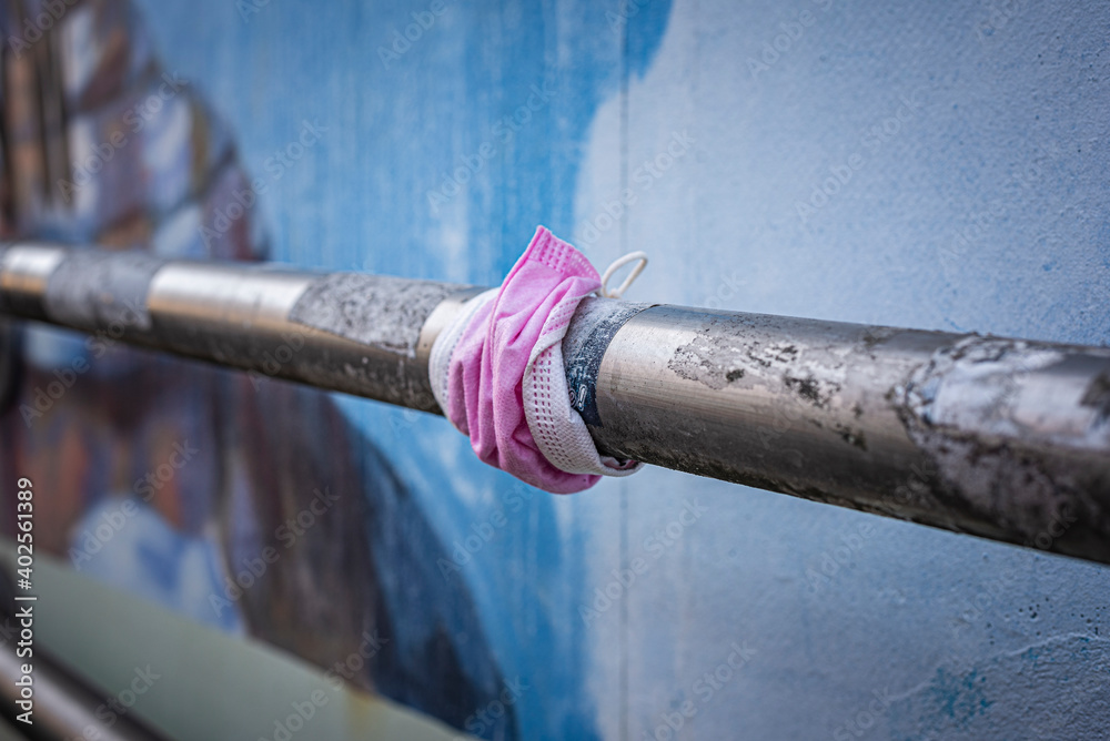 Pink protective mask on a handrail Pink protective mask on a handrail