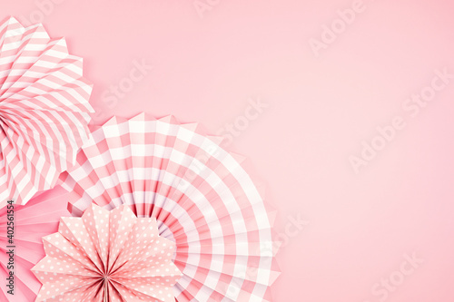 Festive party background with pink paper circle fans over pastel background. Festival  birthday  baby shower decoration