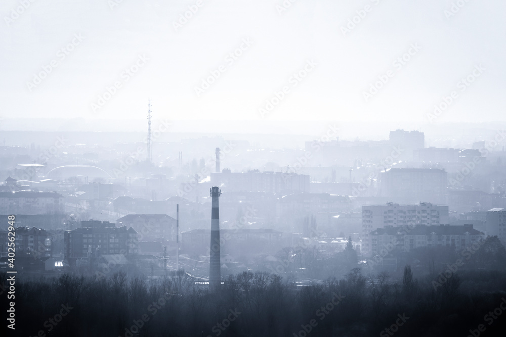 The city's skyline. Panorama of houses in the evening haze.