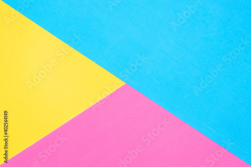 Multicolored paper background. Yellow pink and blue geometric backdrop. Diagonal and triangles