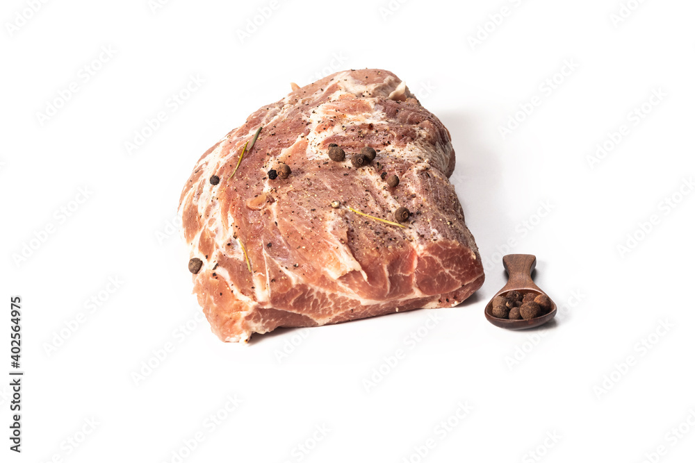 studio lighting. meat of a neck part of pork. On it seasoning, pepper. A white background. Close-up. studio lighting. meat of a neck part of pork. On it seasoning, pepper. A white background. Close-up.