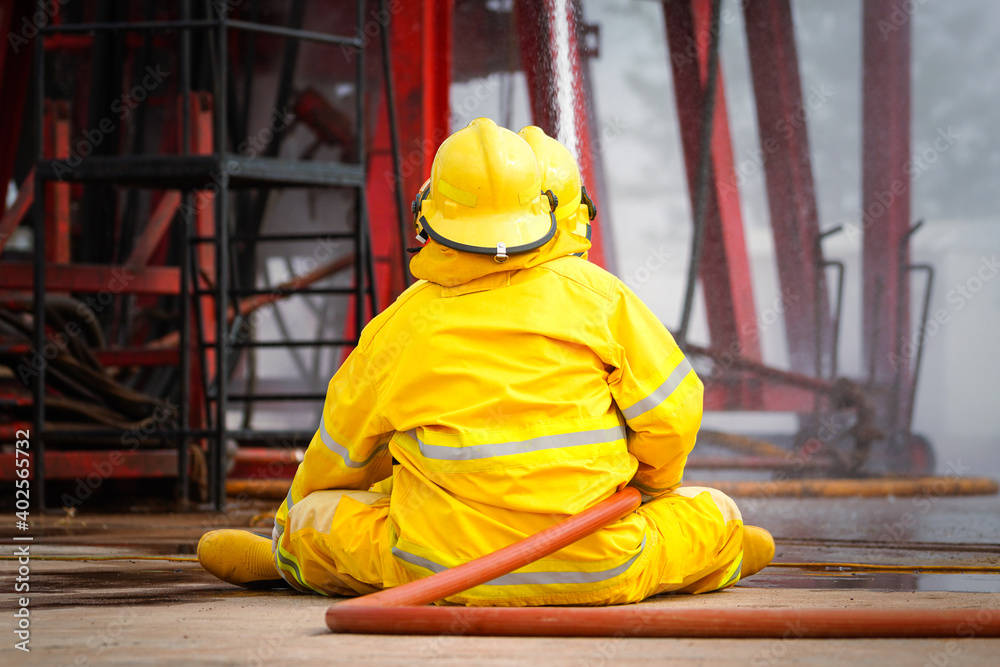 Action of firemen and rescue team in yellow protective safety uniform are sparying water to control the fire accident. Action of firemen and rescue team in yellow protective safety uniform are sparying water to control the fire accident.