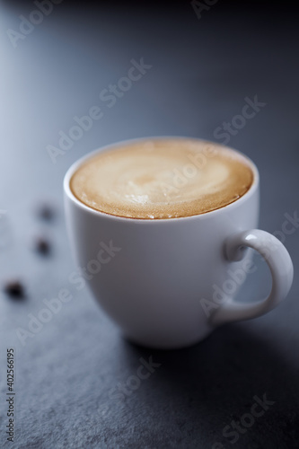 Cup of coffee on dark stone background. Close up. 