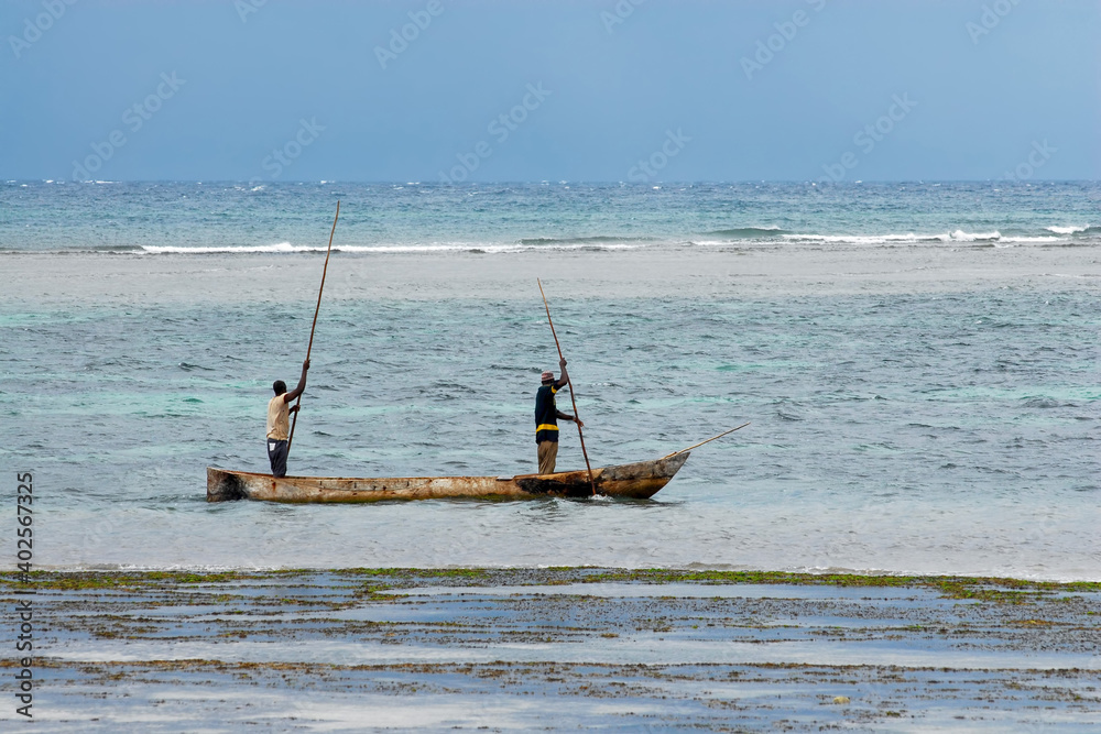 Kenyan fishermen in traditional boat in Indian ocean. Surroundings of Mombasa, Kenya.