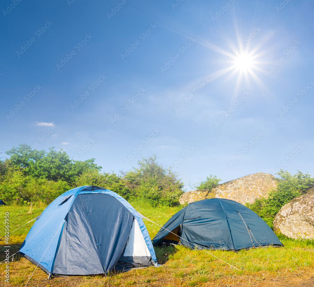 touristic camp in the prairie under a sparkle sun, hiking travel scene