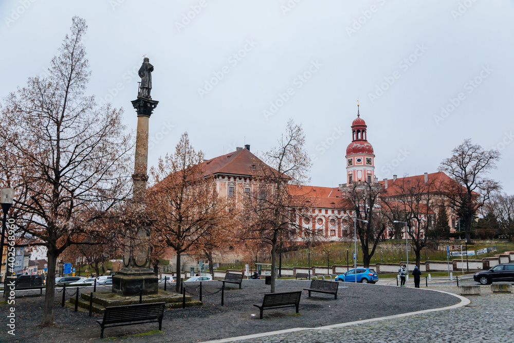 Obraz premium The statue of the Saint Laurel (sv. Vavrince) on the Charles town square (Karlovo namesti) near romantic baroque castle in Roudnice nad Labem, Central Bohemia, Czech Republic