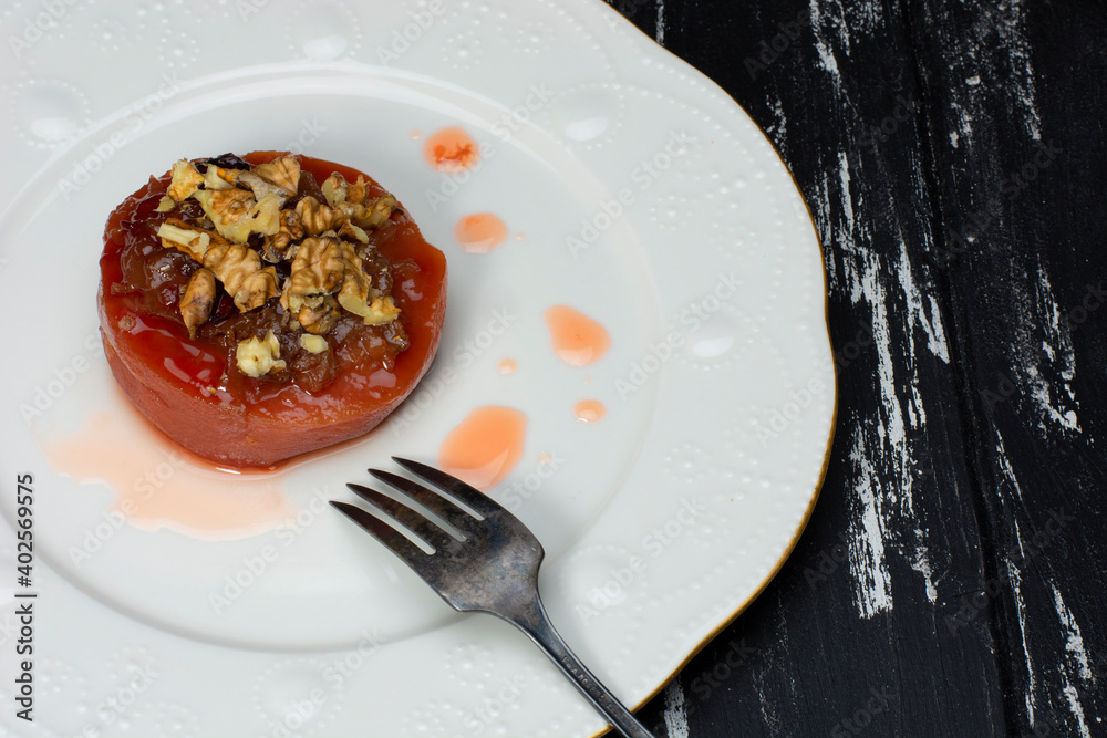 quince dessert with walnuts in a metal plate quince dessert with walnuts in a metal plate