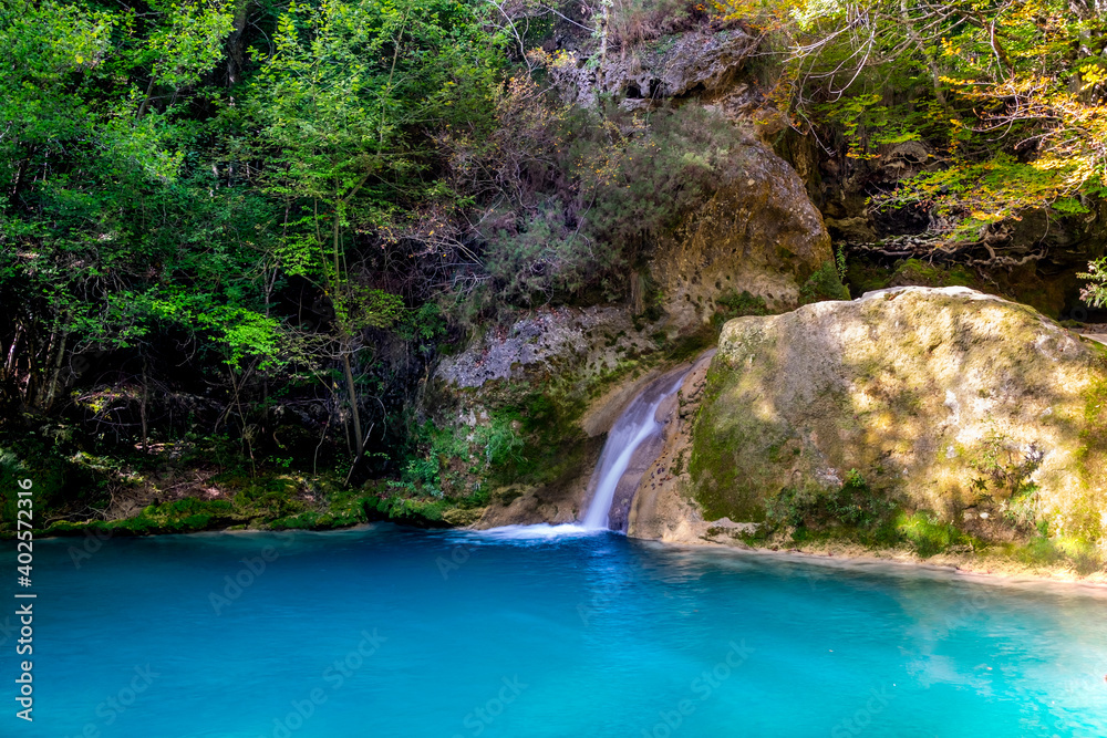 waterfall in the forest, Urederra river springs, Navarra. Spain 
