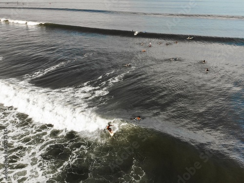 A local surfer trims down the line of an open wave - Medewi, Bali