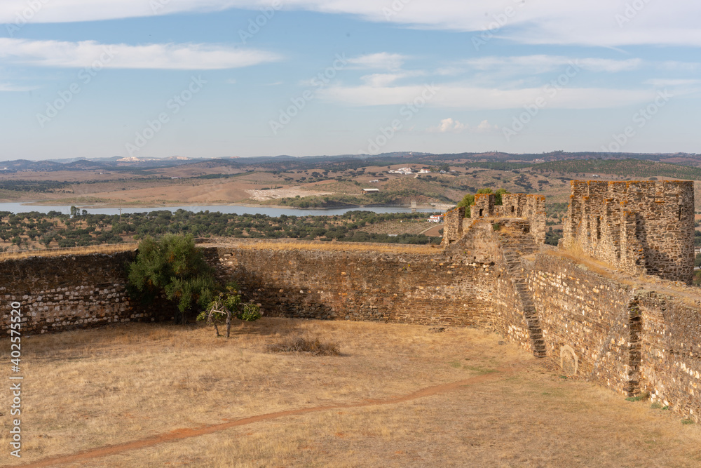 Interior of Terena Castle with a dam lake reservoir on the background and the village of Terena in Alentejo, Portugal