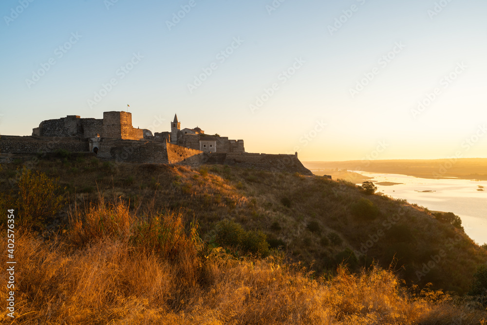 Juromenha castle and Guadiana river and border with Spain on the side of the river at sunrise, in Portugal