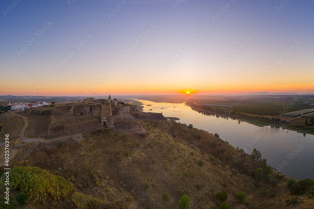 Juromenha castle, village and Guadiana river drone aerial view at sunrise in Alentejo, Portugal