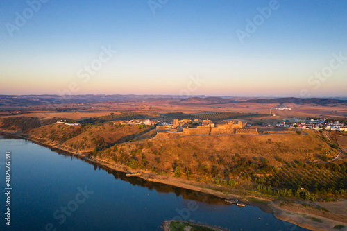 Juromenha castle, village and Guadiana river drone aerial view at sunrise in Alentejo, Portugal