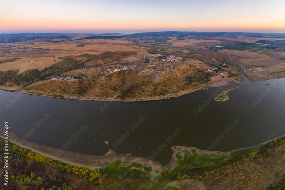 Juromenha castle, village and Guadiana river drone aerial view at sunset in Alentejo, Portugal and Spain on the foreground