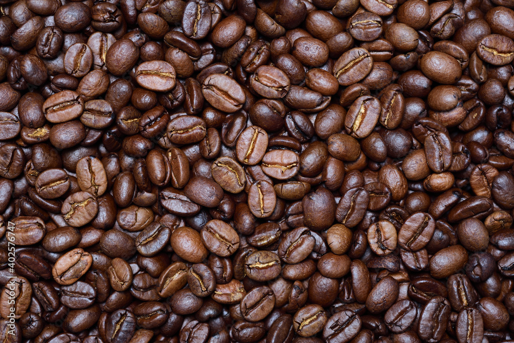 Naklejka premium Close up, texture and background of roasted fresh coffee beans