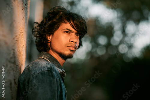 Photography Handsome long hair young man portrait at outdoor in evening light