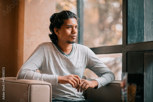Canvas Print Handsome long hair young man portrait at outdoor in evening light