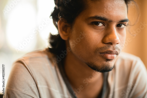 Handsome long hair young man portrait at outdoor in evening light.