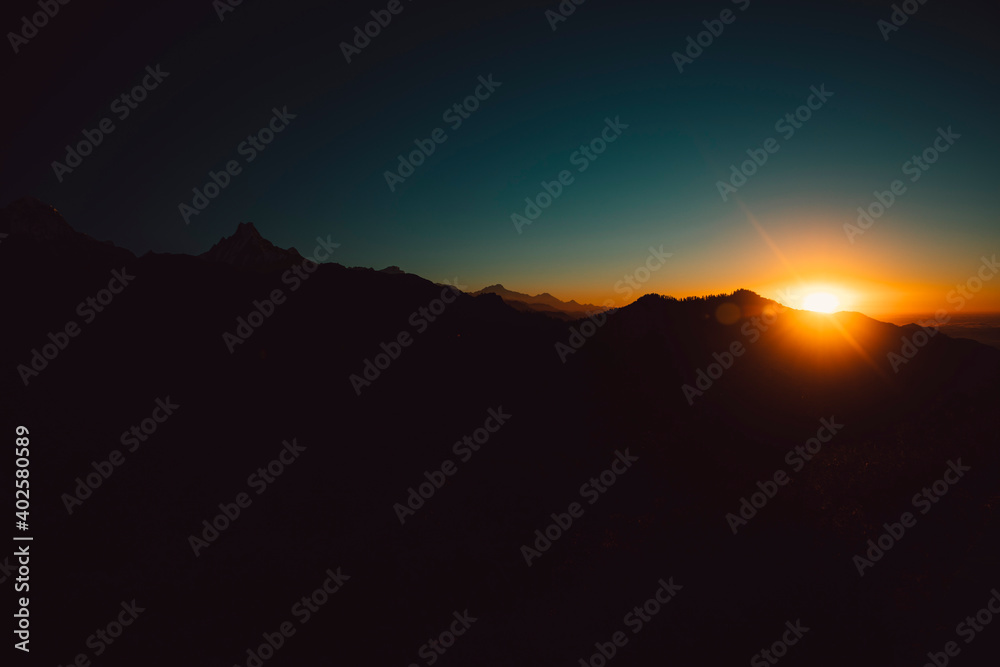 Himalayan mountain peak Annapurna Range silhouette with sunrise.