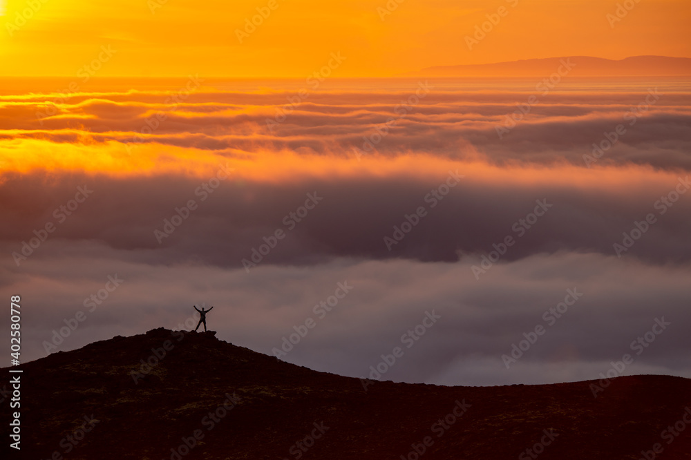  Dreamy misty landscape above the sea of clouds, mountains at sunset in Iceland