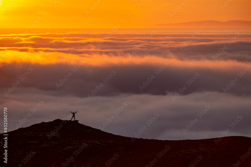 Dreamy misty landscape above the sea of clouds, mountains at sunset in Iceland Dreamy misty landscape above the sea of clouds, mountains at sunset in Iceland