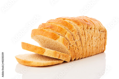 The cut loaf of wheat bread with reflection isolated on white