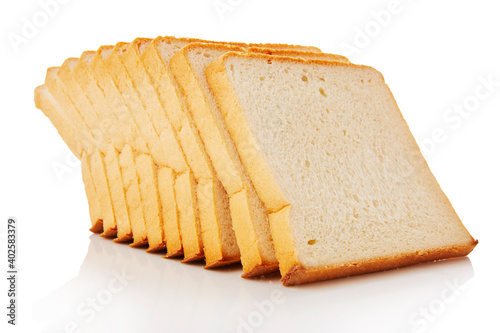 The cut loaf of white bread with reflection on white
