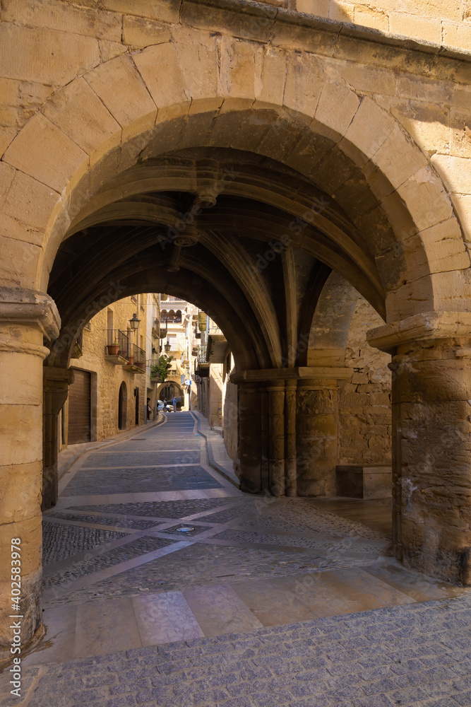 View of one of the arcaded streets of the medieval historic center of Calaceite, Aragon, Spain