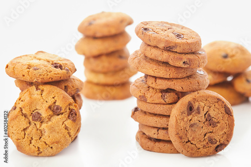 Stack of Chocolate chip cookies on white.