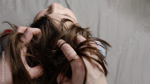 mom gives head massage to daughter at home top view photo