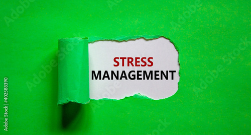 Stress management symbol. Words 'Stress management' appearing behind torn green paper. Business, psychological and stress management concept. Copy space.