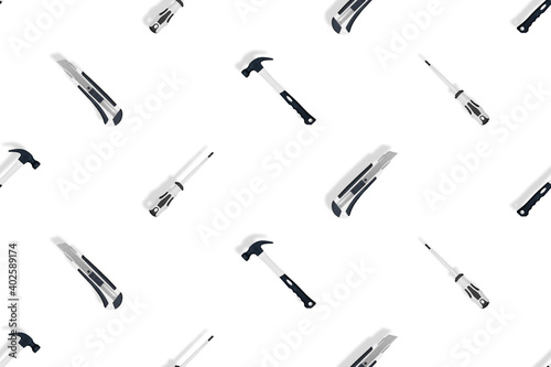 Tools seamless pattern. Tools: hammer, screwdriver and knife on a white background.