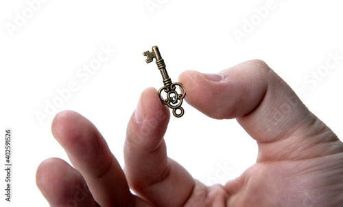 man's hand holds a magic key on a white background