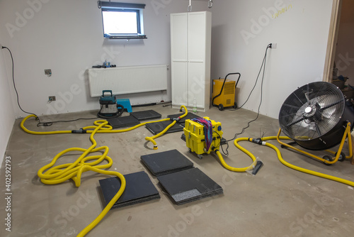 Drying a concrete floor under a fabric covering. After pouring, initial drying, and then drilling and blowing hot air