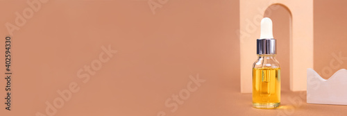 Mockup image of dropper bottle - natural organic cosmetics, hyaluronic acid, serum, moisturizer or facial anti-aging oil. Essential oil in trendy biege still life composition, banner. Selective focus photo