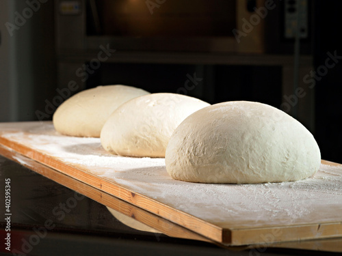 leavening bread dough on a wooden surface