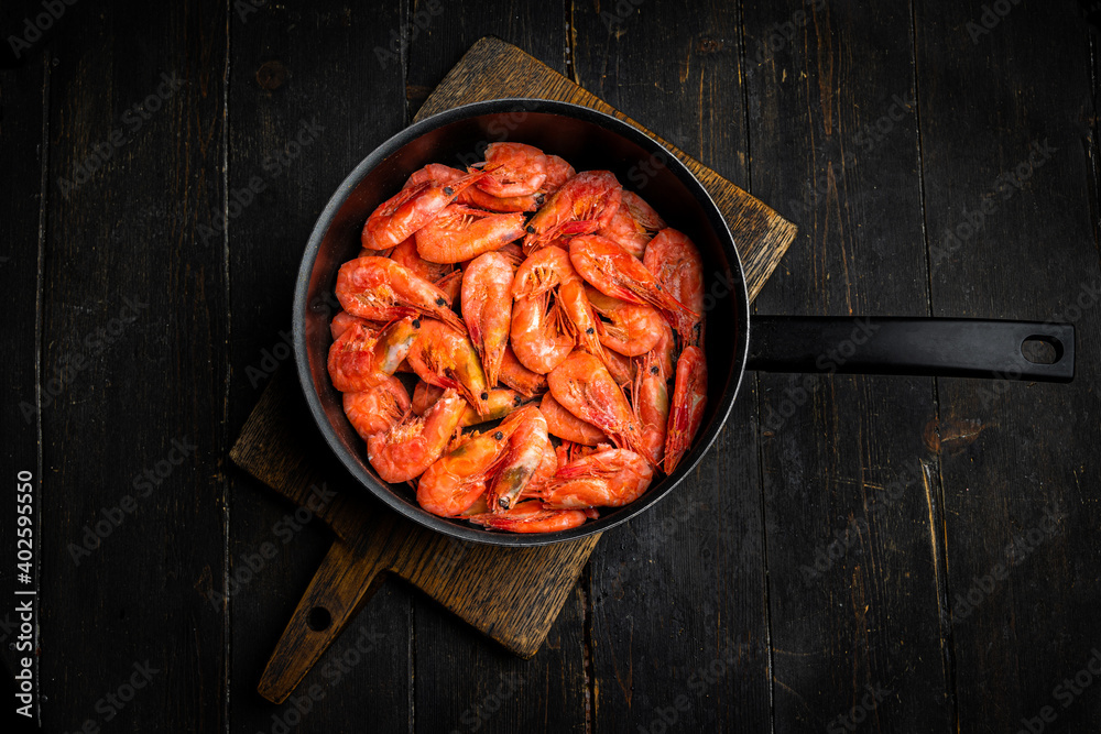 Raw Northern shrimps or prawns in a frying pan . Top view Raw Northern shrimps or prawns in a frying pan . Top view