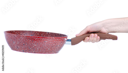 Granite coated frying pan with glass lid in hand on white background isolation photo