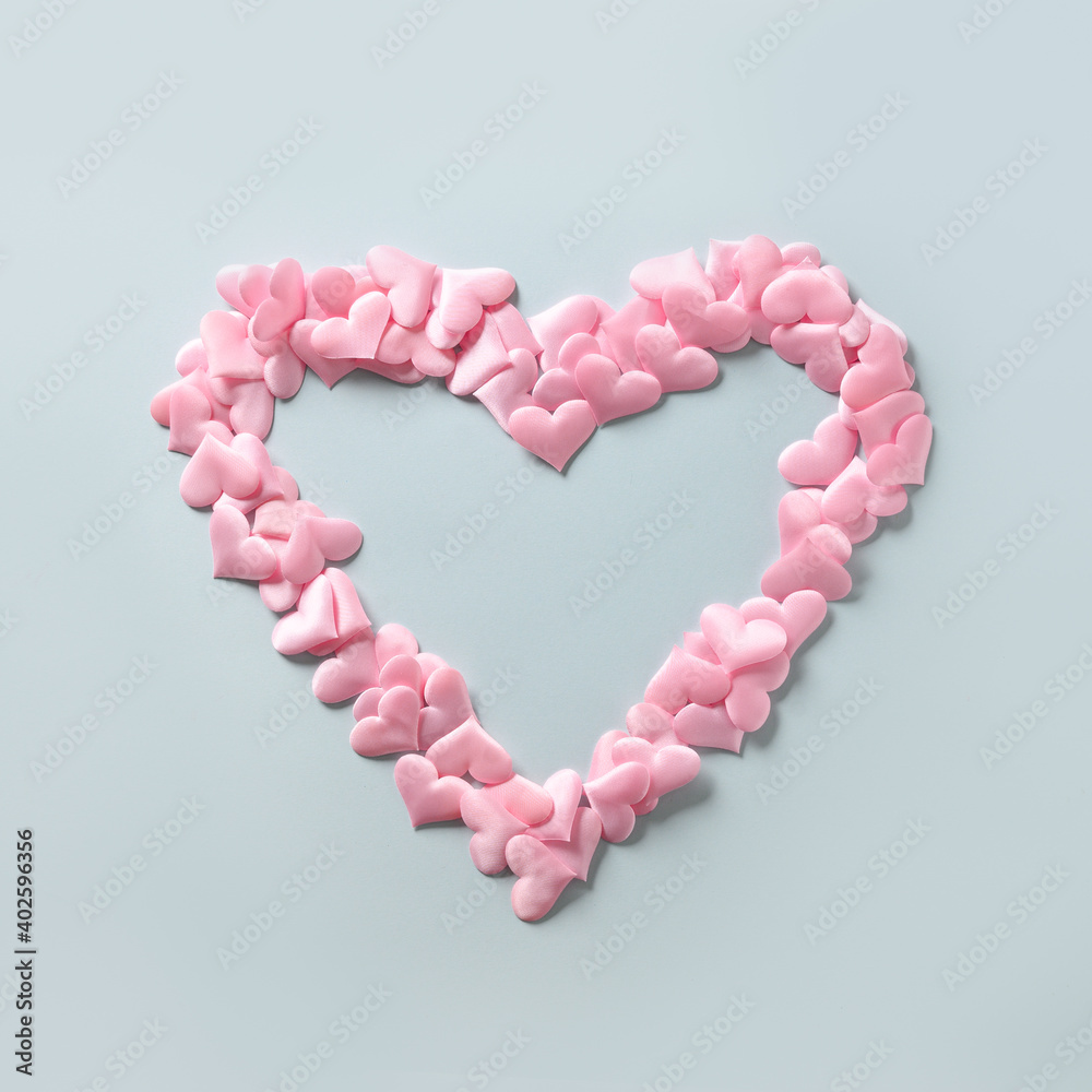 Pink hearts in shape in big heart on blue background. Valentine's day square greeting card with copy space. Love concept.