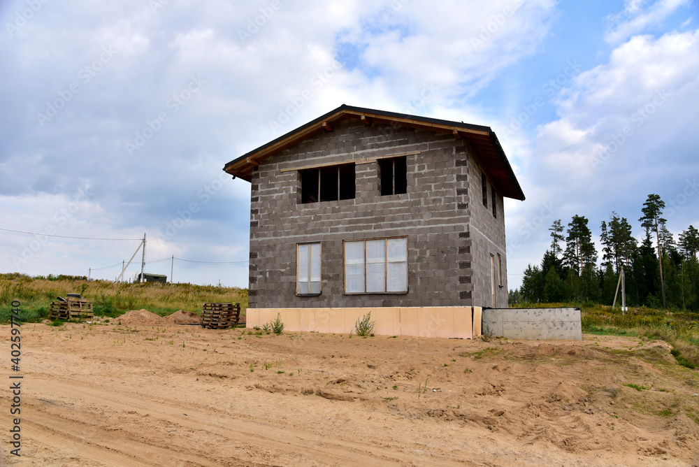 Building a house of expanded-clay concrete blocks. Unfinished private home of ceramsite concrete blocks on a construction site.Technology of construction work and laying bricks Building a house of expanded-clay concrete blocks. Unfinished private home of ceramsite concrete blocks on a construction site.Technology of construction work and laying bricks