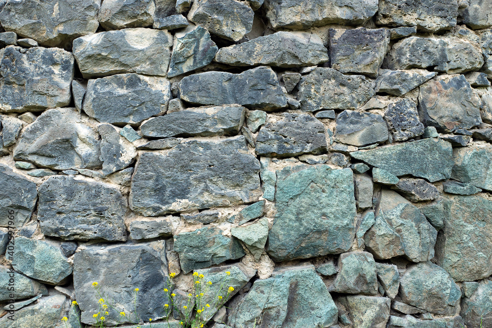 Background with a fragment of a stone wall of an ancient armenian monastery Background with a fragment of a stone wall of an ancient armenian monastery